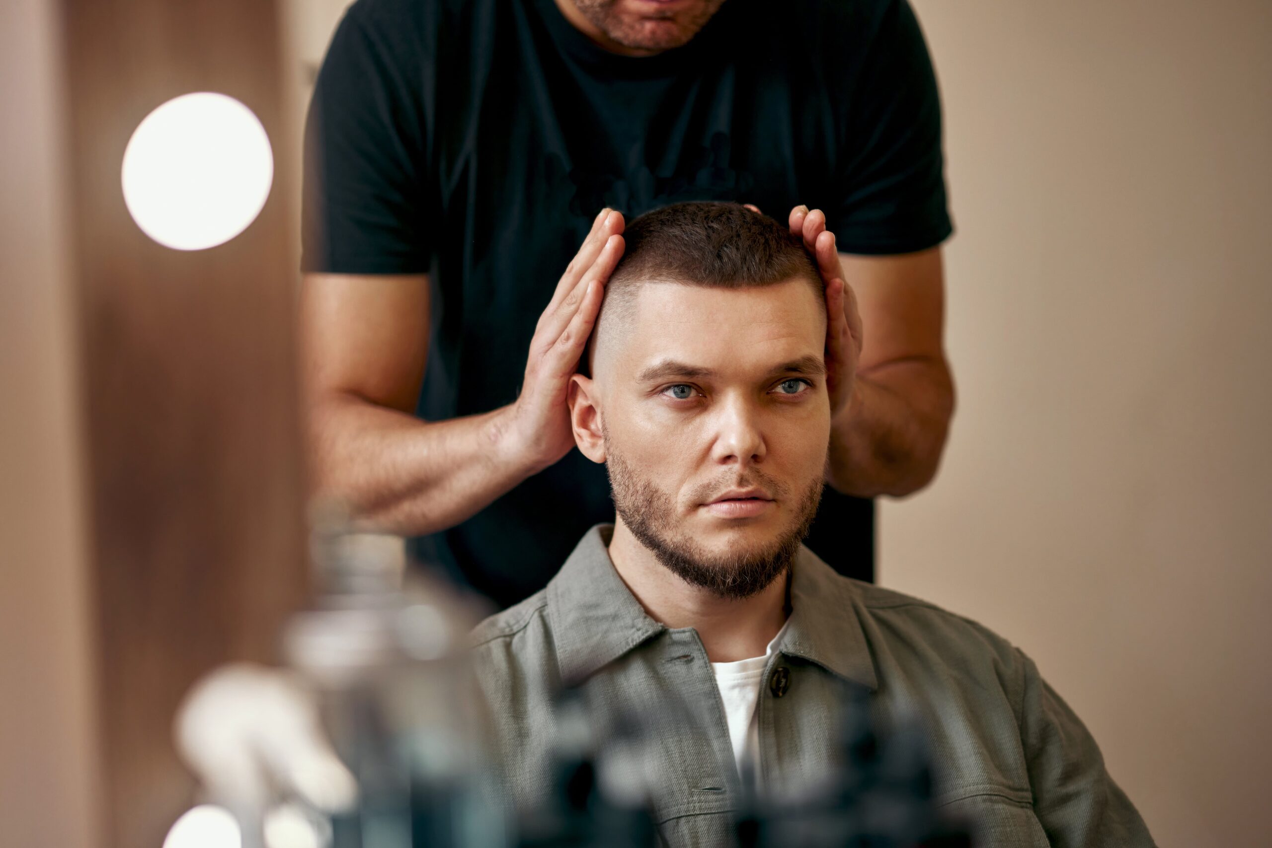 Man receiving high and tight haircut at barbershop