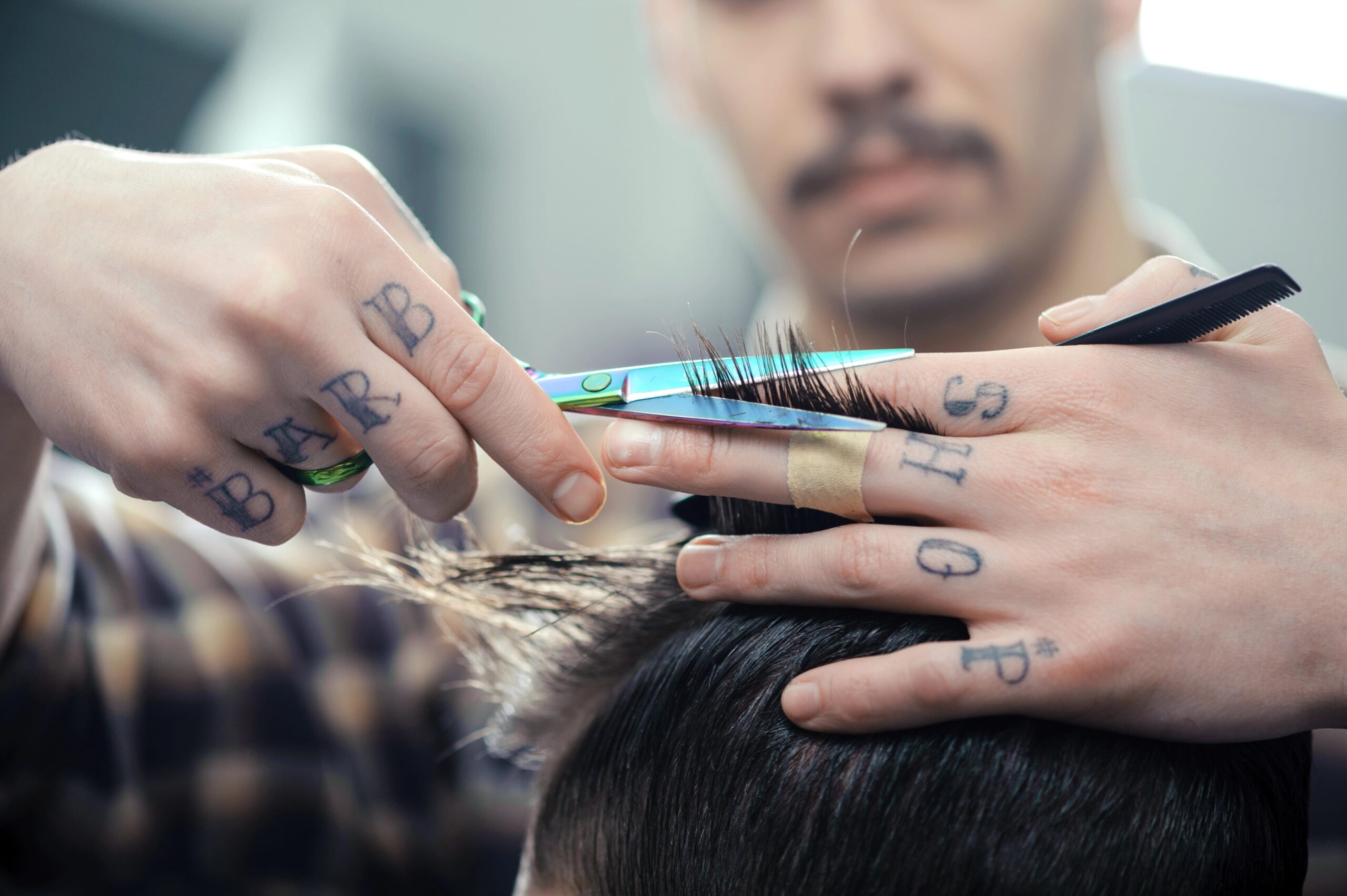 Close-up of barber trimming hair