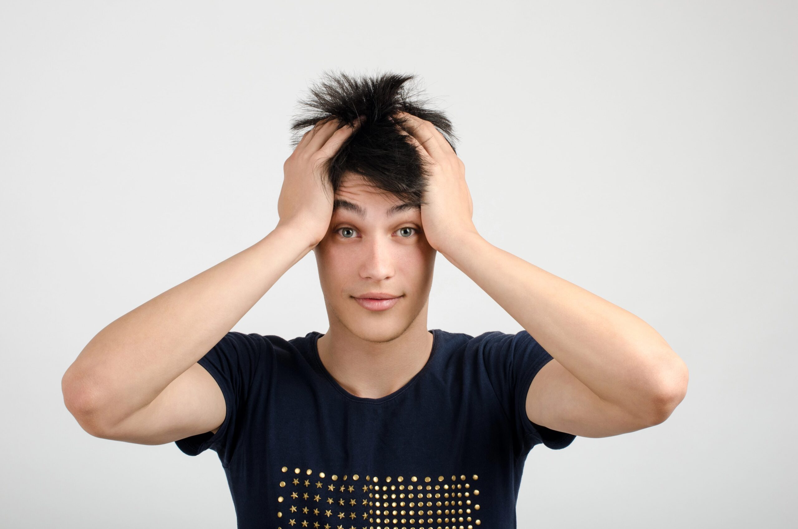 Man with hands in wild hair
