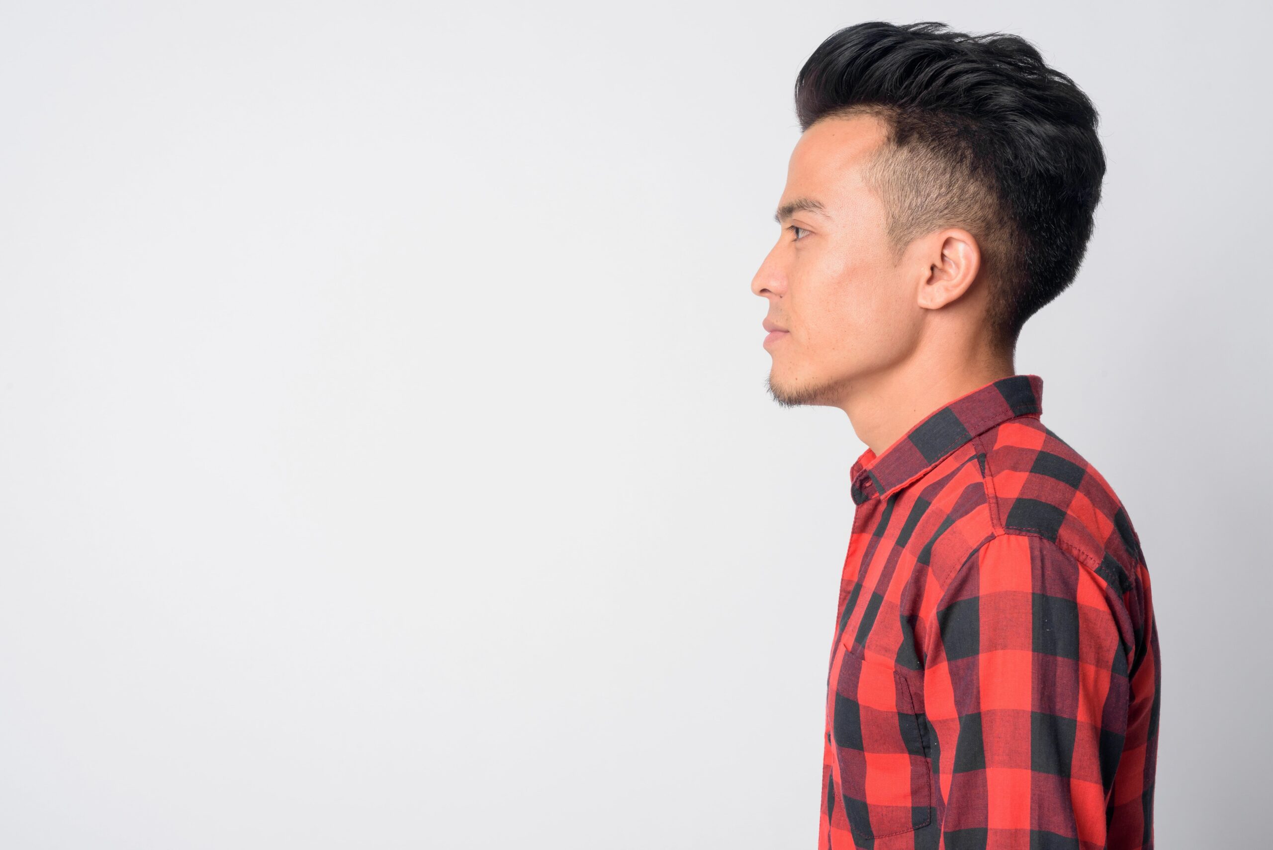 Portrait of man facing to the side with faux hawk haircut