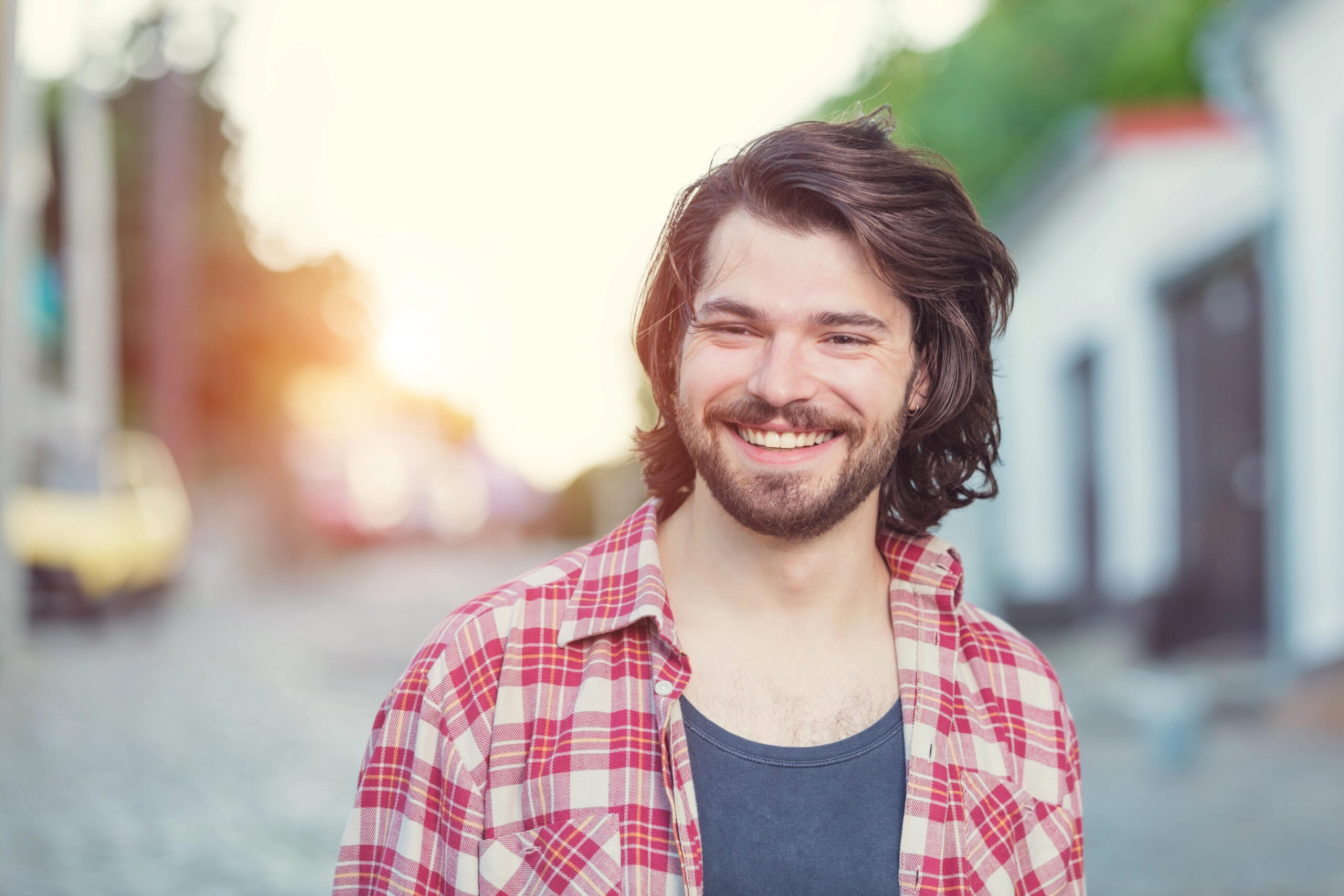 Smiling young man with longer hair, hockey flow haircut